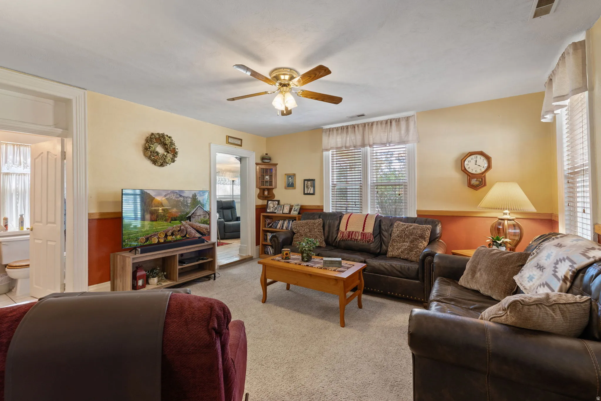 Formal living room featuring a ceiling fan