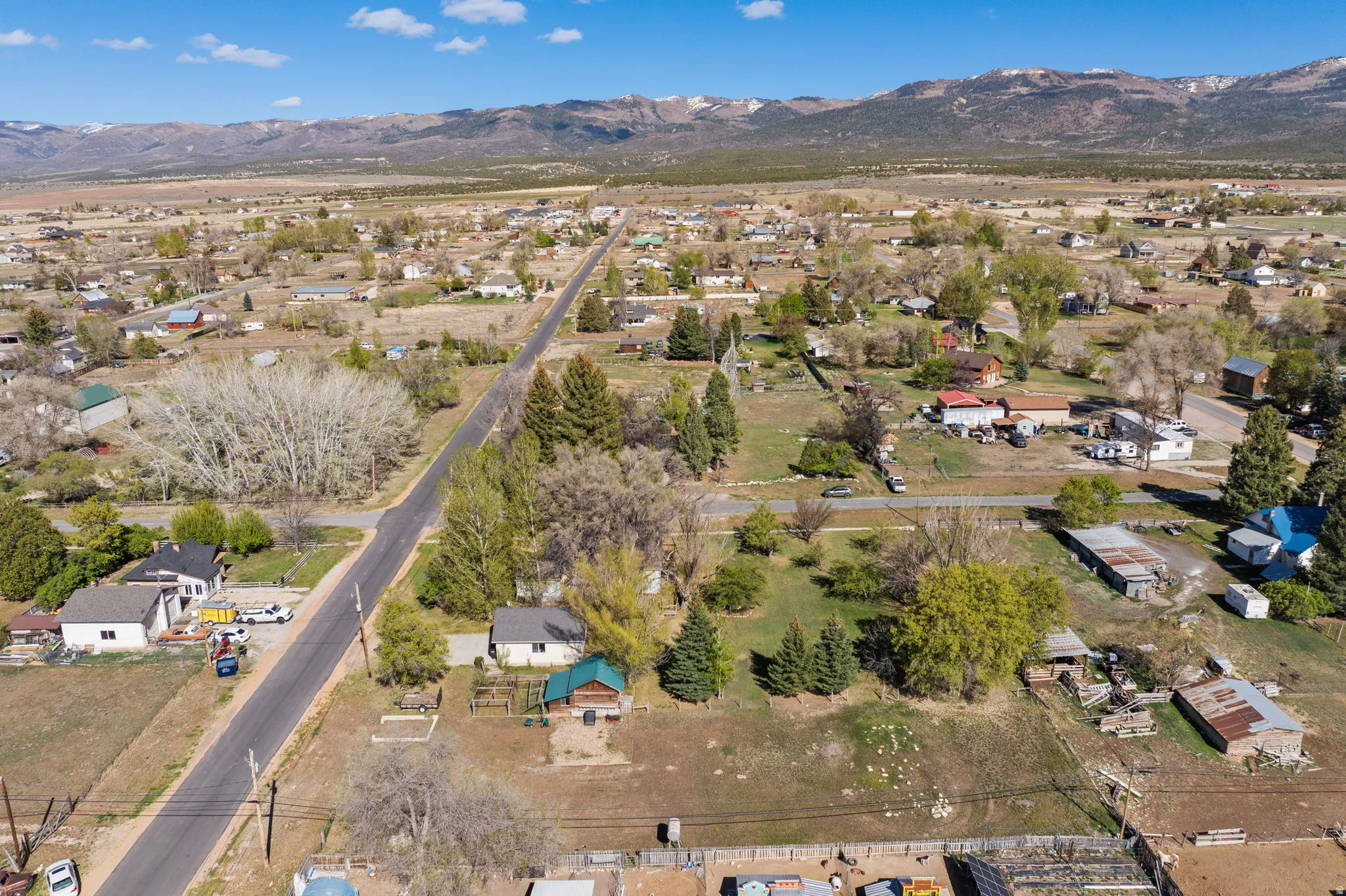 Aerial view of property's location with a mountainous background and nearby suburban area