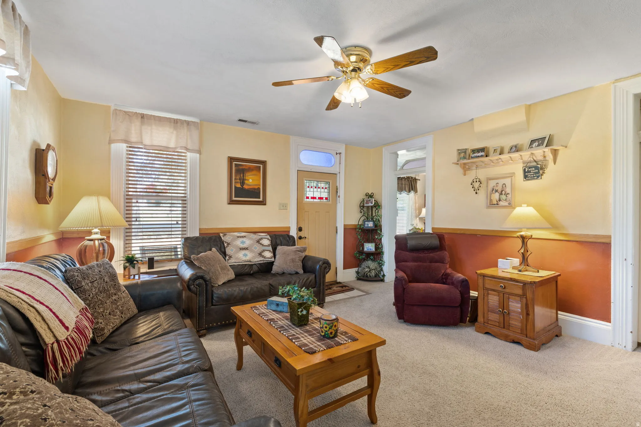 Formal living area featuring a ceiling fan and baseboards