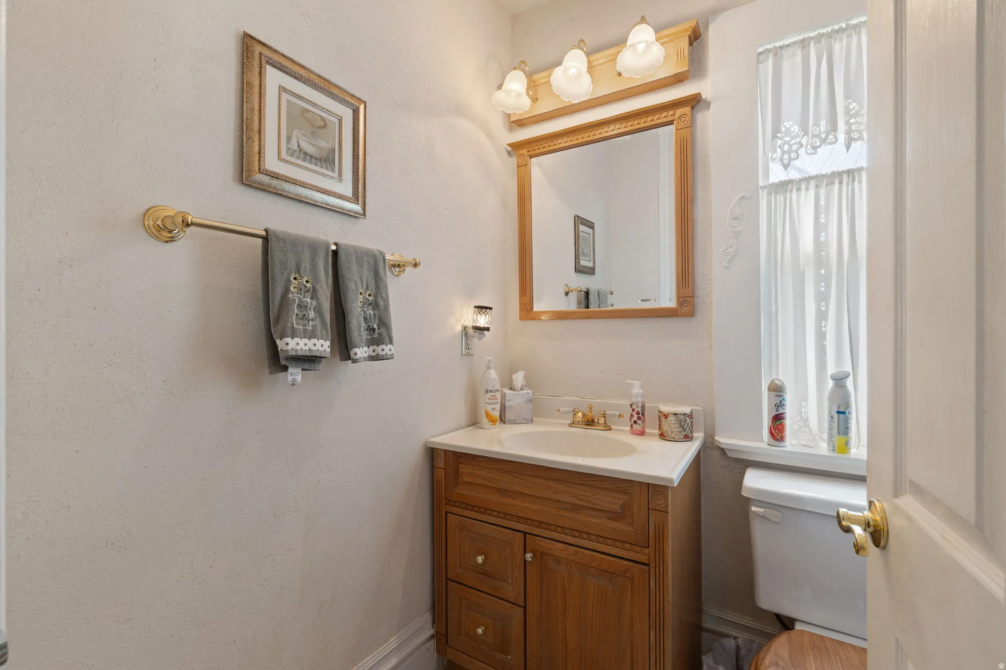 Bathroom with vanity and a textured wall