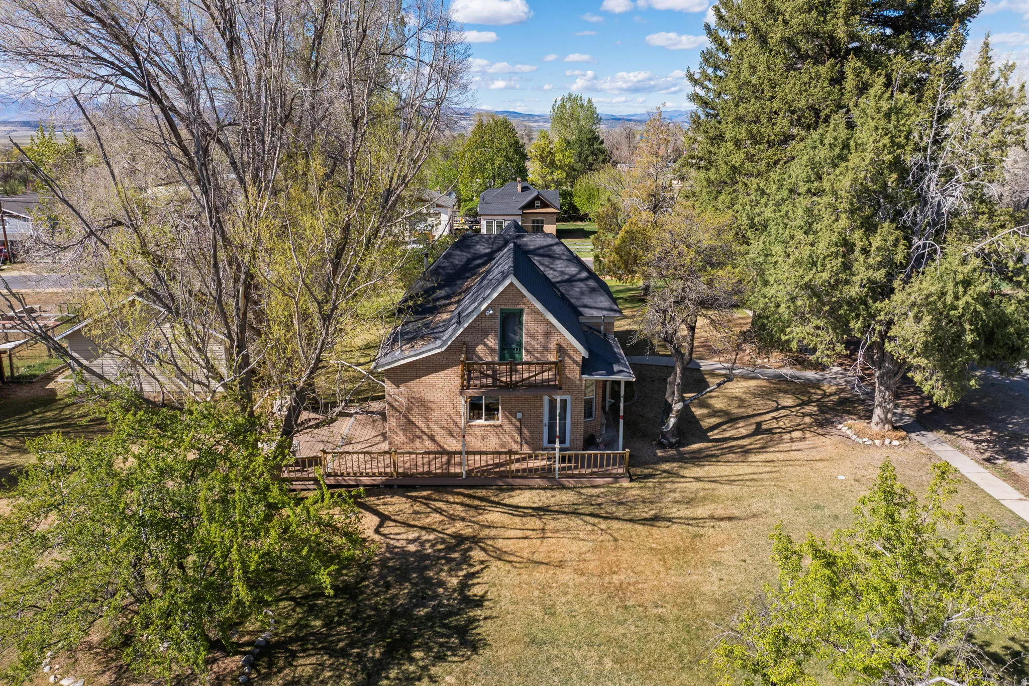 Back of house featuring brick siding