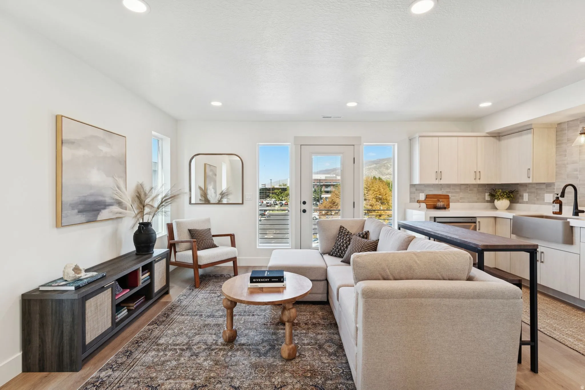 Living room with light wood-style floors and recessed lighting