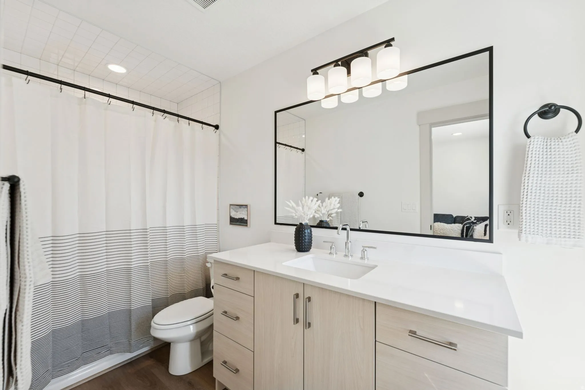 Full bath with vanity, dark wood-type flooring, and recessed lighting