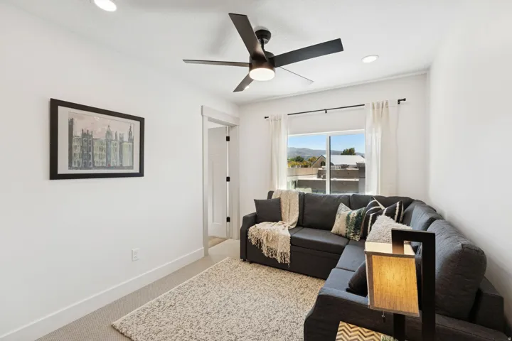Living area with light carpet, recessed lighting, and a ceiling fan