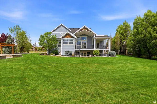 Rear view of property with a yard and covered porch