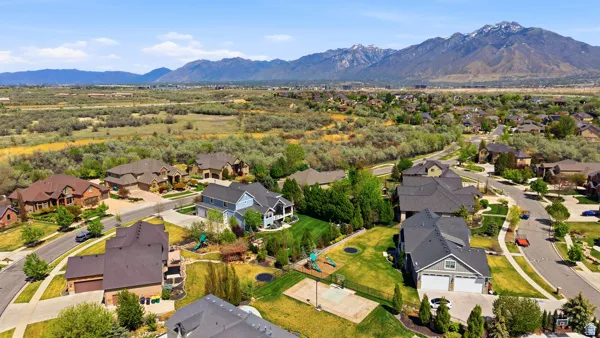 Aerial perspective of suburban area featuring a mountainous background