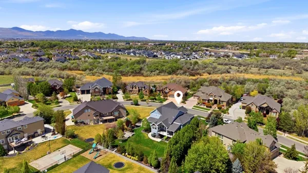 Aerial perspective of suburban area featuring a mountain backdrop