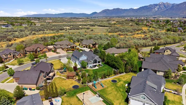 Aerial perspective of suburban area featuring a mountainous background