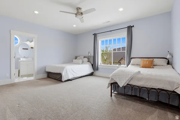Bedroom featuring light colored carpet, recessed lighting, ceiling fan, and connected bathroom