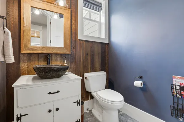 Bathroom with vanity and wood walls