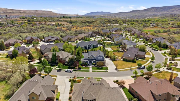 Aerial view of property and surrounding area featuring nearby suburban area
