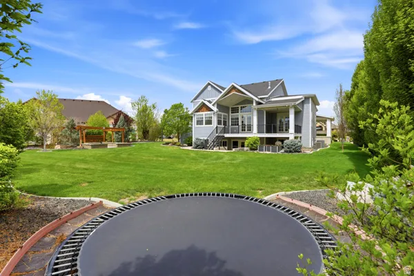 Rear view of property with a yard and a patio