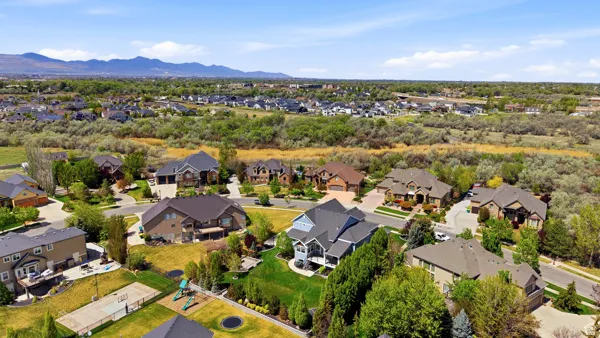 Aerial perspective of suburban area with a mountain backdrop