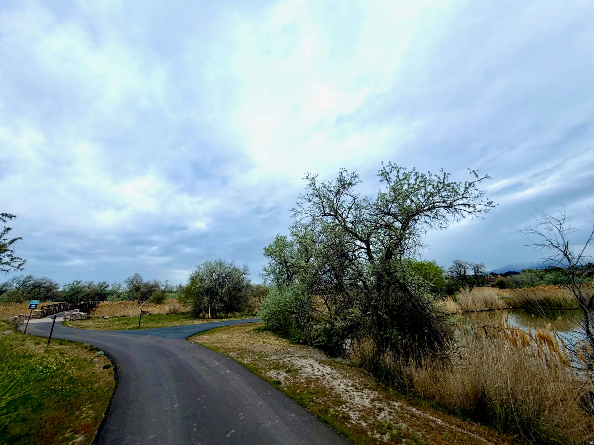 View of asphalt road featuring a water view