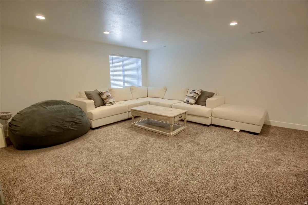 Living area featuring carpet floors and recessed lighting