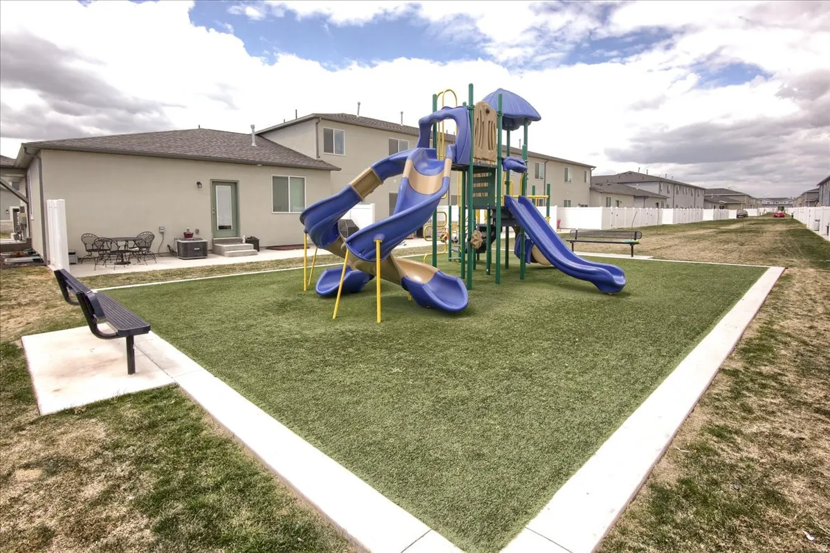 Community jungle gym featuring a patio and a residential view