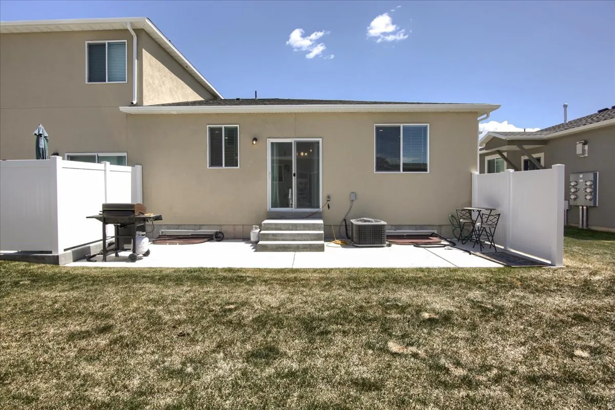 Back of house featuring a patio area, entry steps, and stucco siding