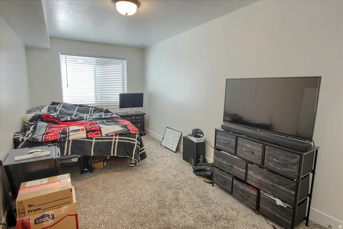 Bedroom featuring light colored carpet