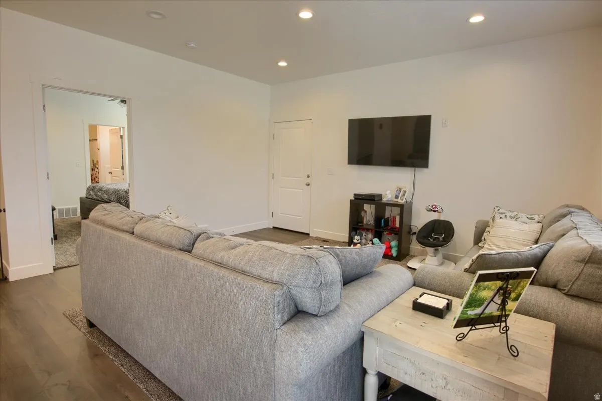 Living area with recessed lighting and wood finished floors