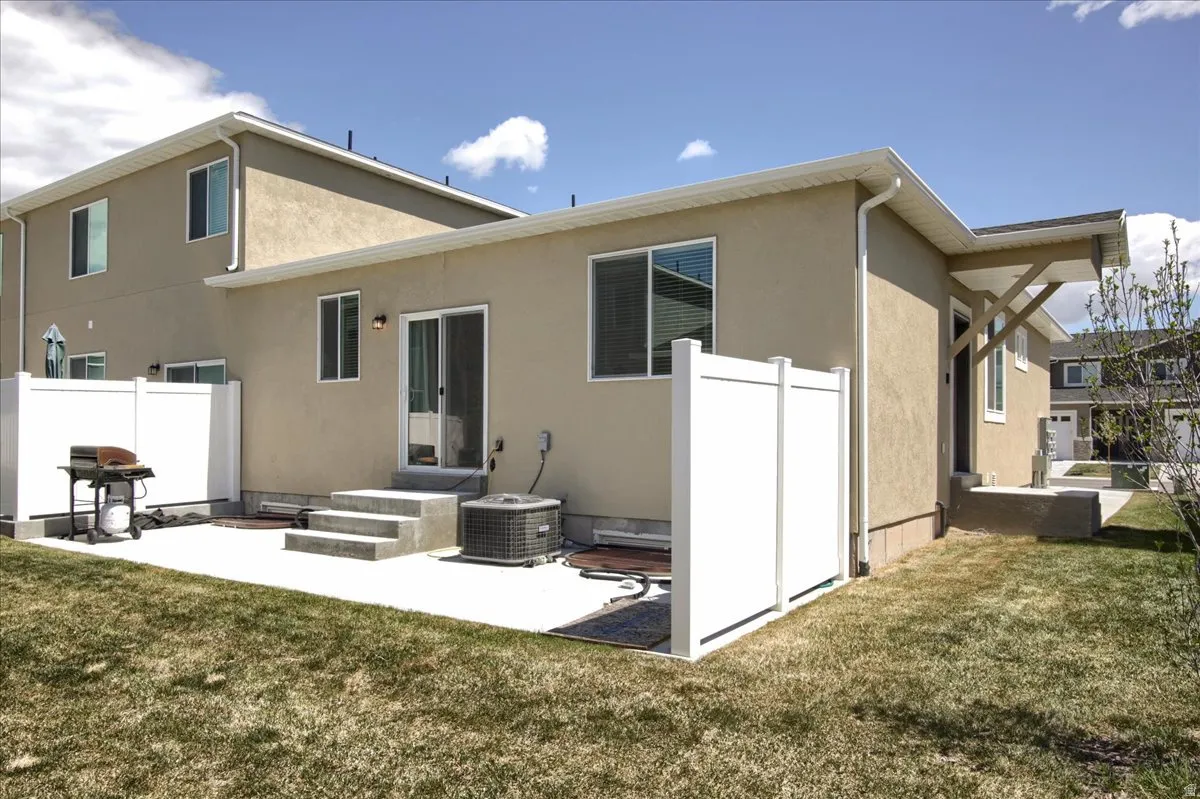 Back of property featuring a patio and stucco siding