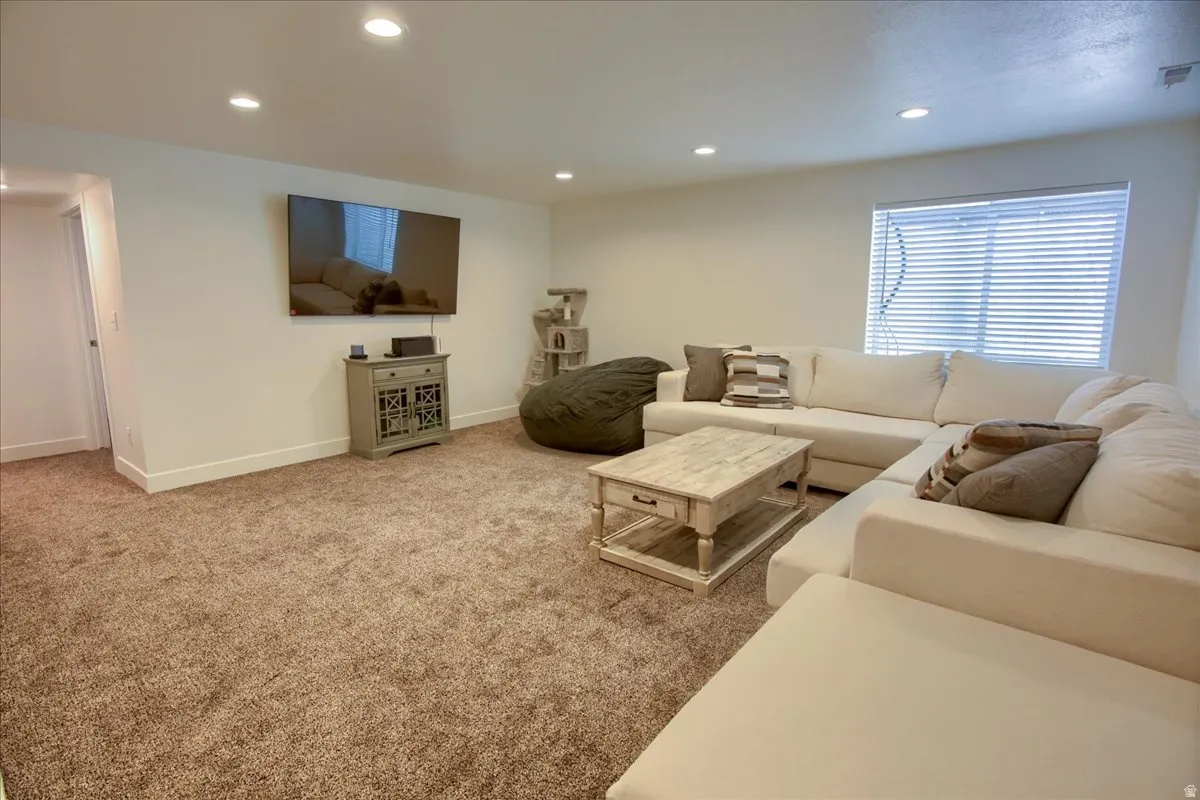 Living room featuring recessed lighting and light colored carpet