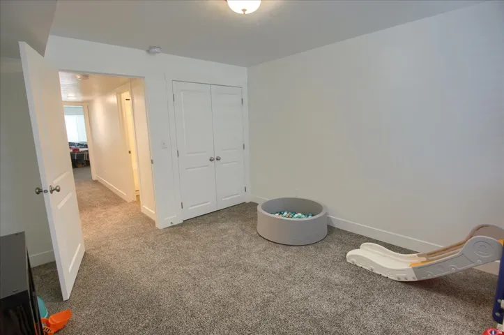 Unfurnished bedroom with carpet flooring and a closet