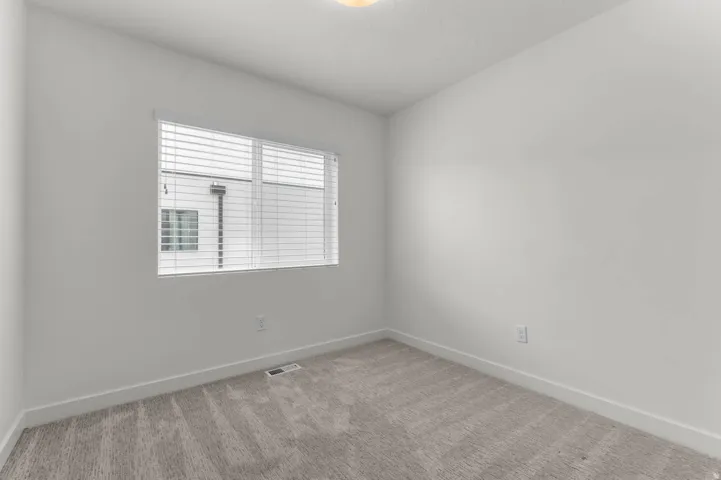 Unfurnished room featuring baseboards and carpet flooring