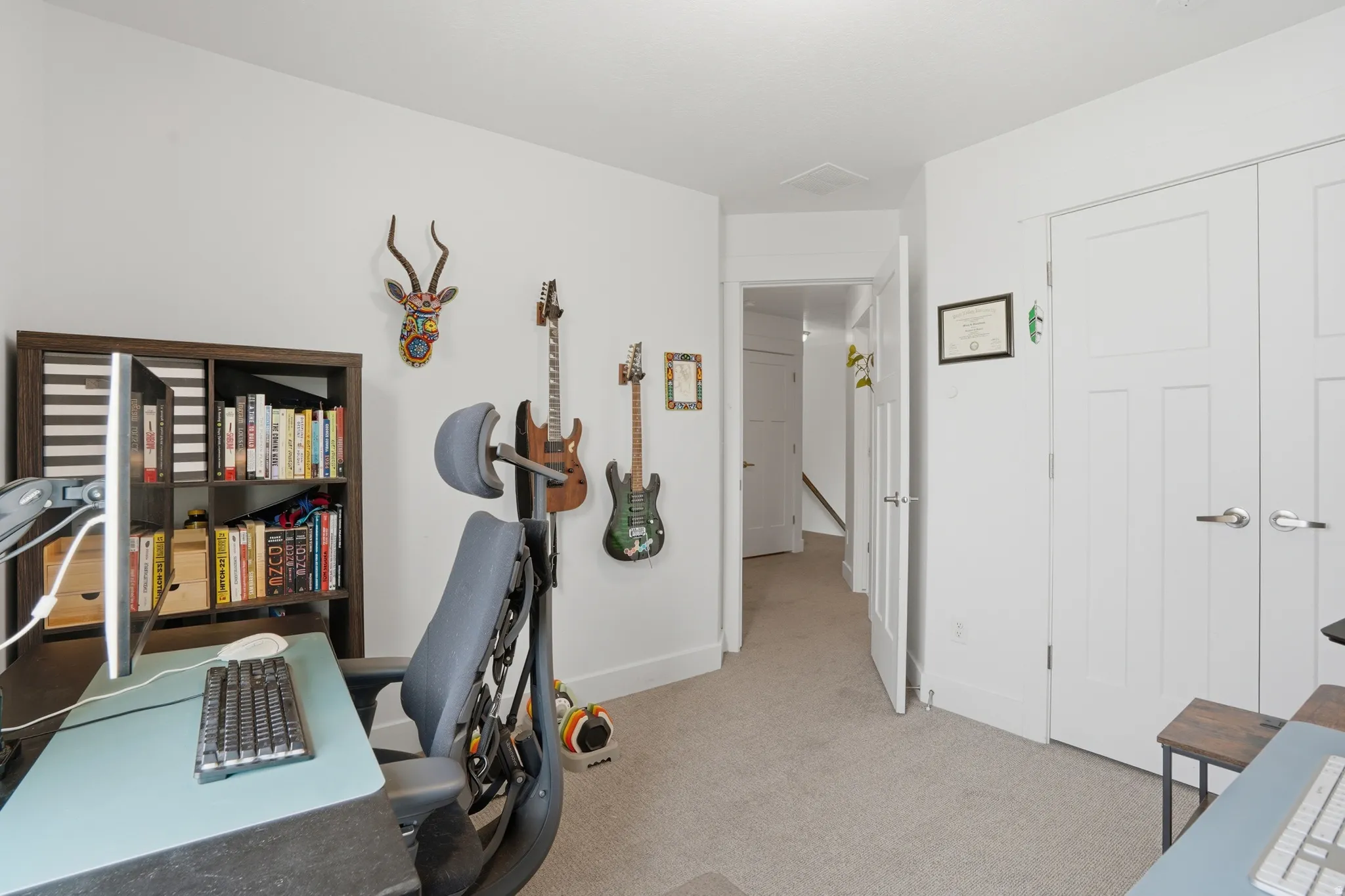 Home office featuring light colored carpet and baseboards