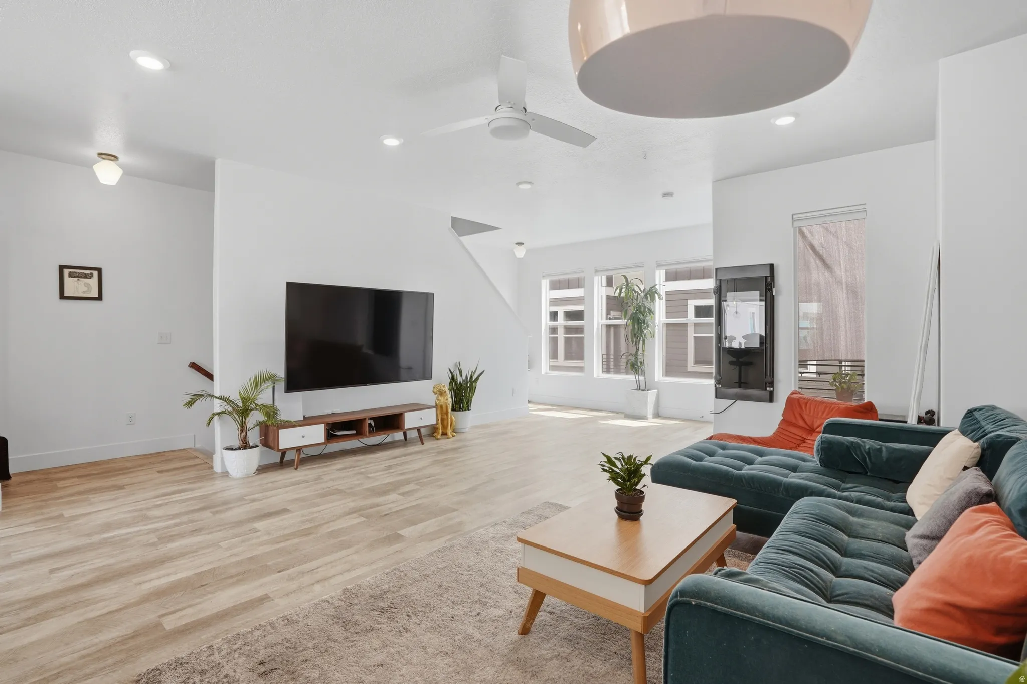 Living area featuring light wood-type flooring, recessed lighting, and a ceiling fan