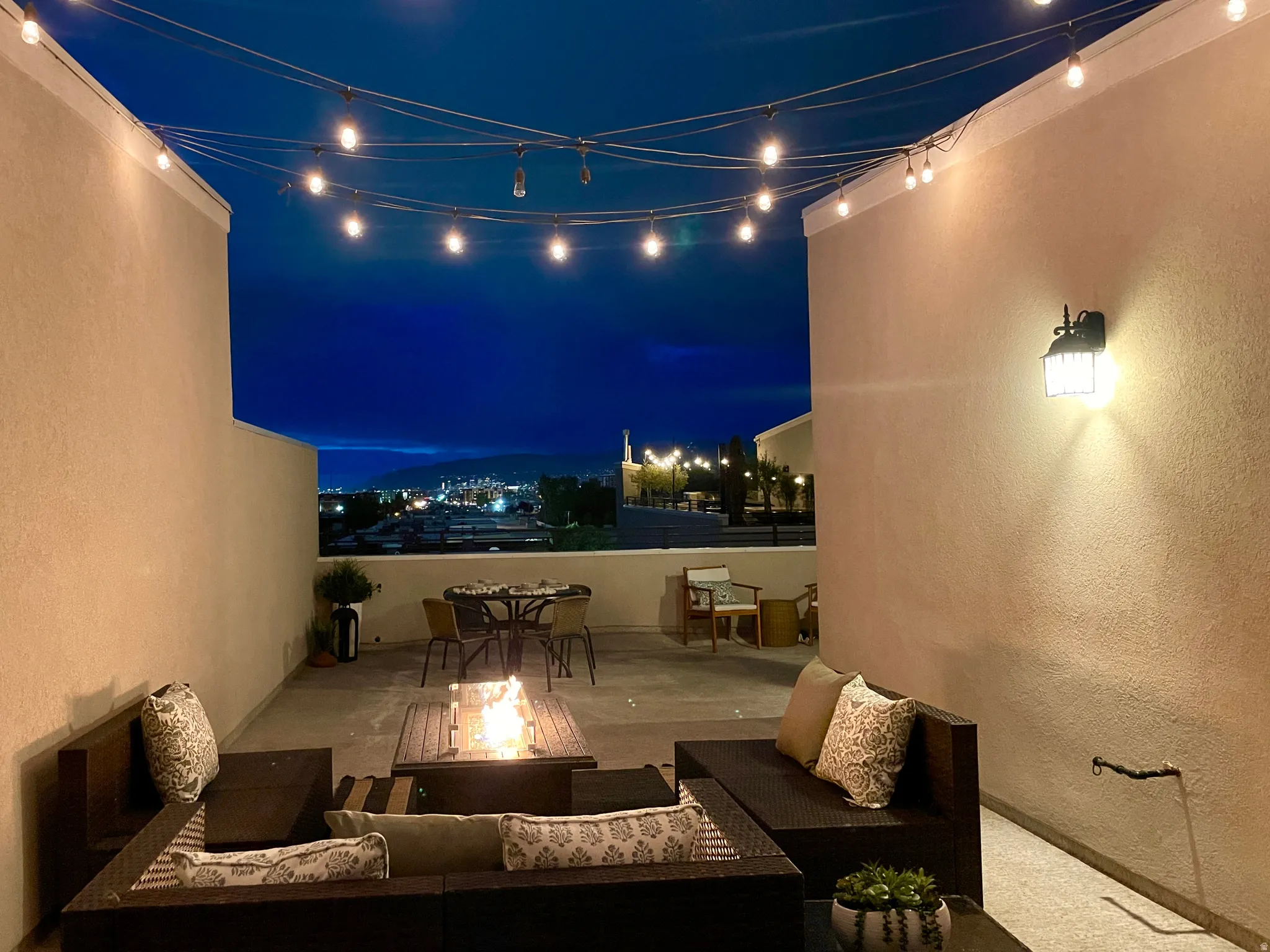 Patio at night featuring a patio area, an outdoor fire pit, and outdoor lounge area