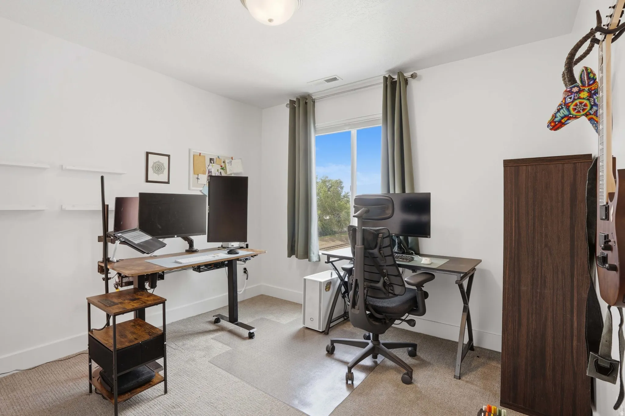Office area with light colored carpet and baseboards