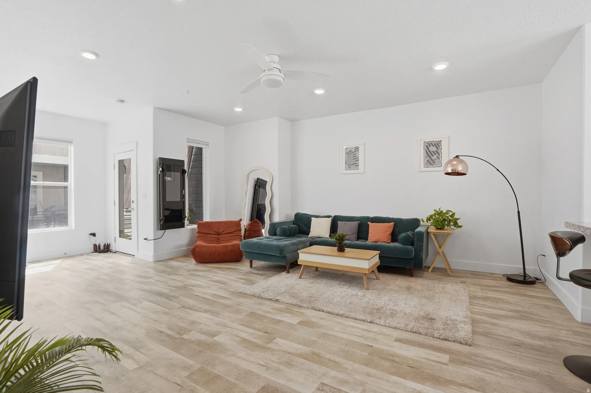 Living area featuring ceiling fan, light wood-type flooring, and recessed lighting