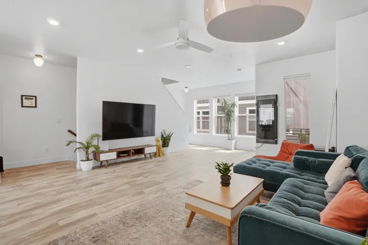 Living area featuring light wood-type flooring, recessed lighting, and a ceiling fan