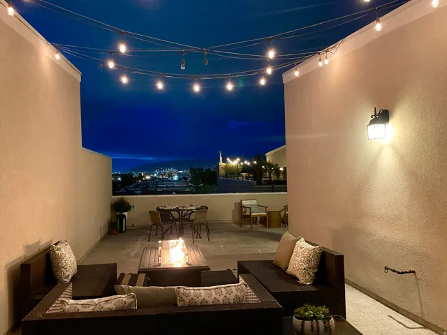 Patio at night featuring a patio area, an outdoor fire pit, and outdoor lounge area