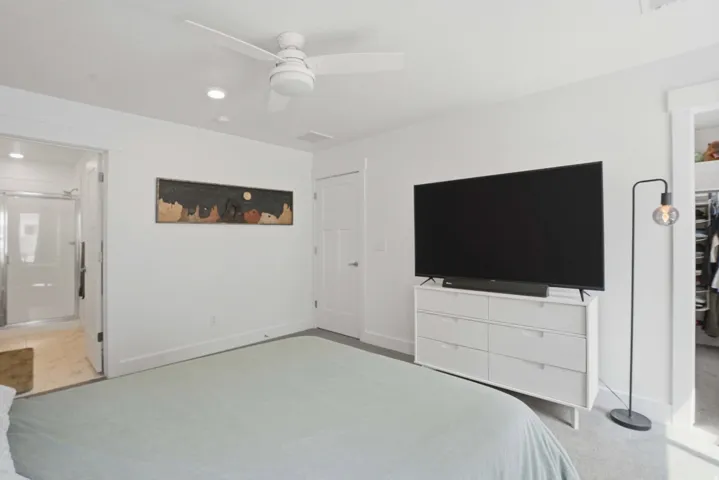 Bedroom featuring a ceiling fan, recessed lighting, and connected bathroom