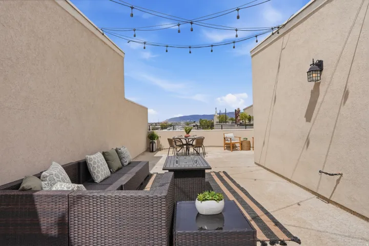 View of patio with a mountain view and an outdoor living / dining area