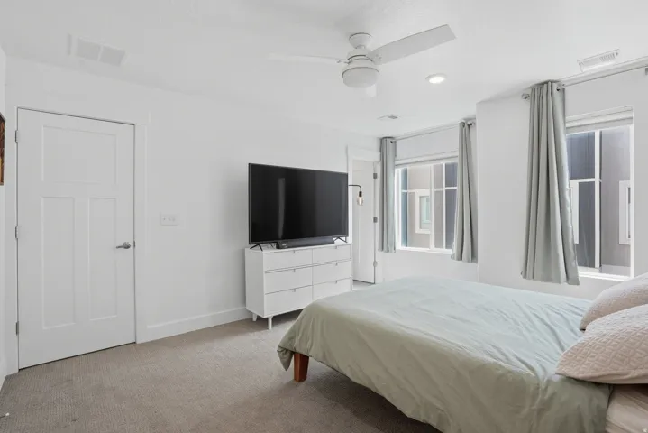 Bedroom featuring light carpet and ceiling fan