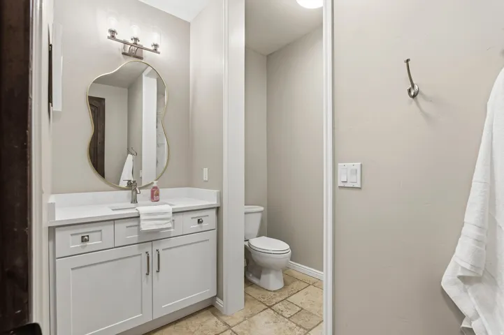 Bathroom with stone tile floors and vanity