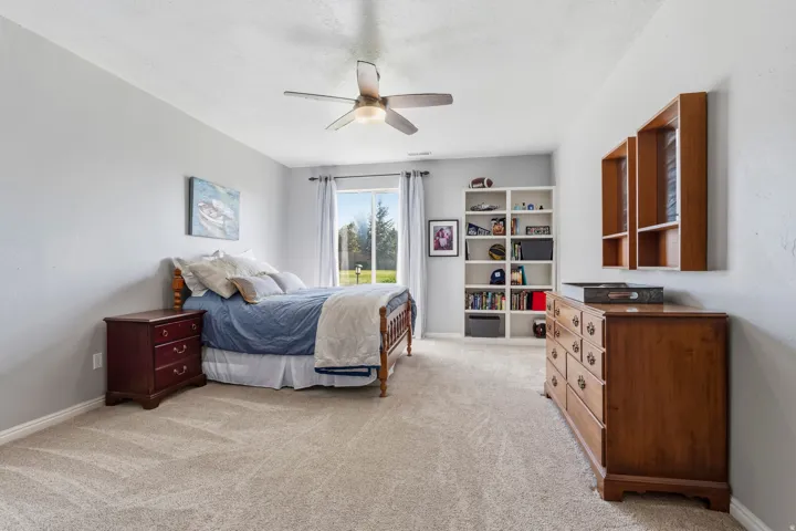 Bedroom featuring light carpet and ceiling fan