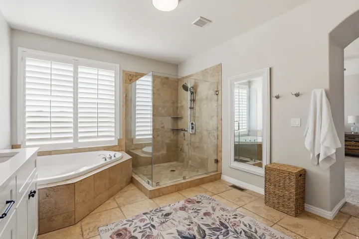 Bathroom with a shower stall, a bath, and vanity