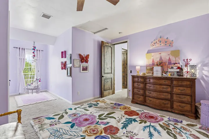 Bedroom featuring light carpet and a ceiling fan