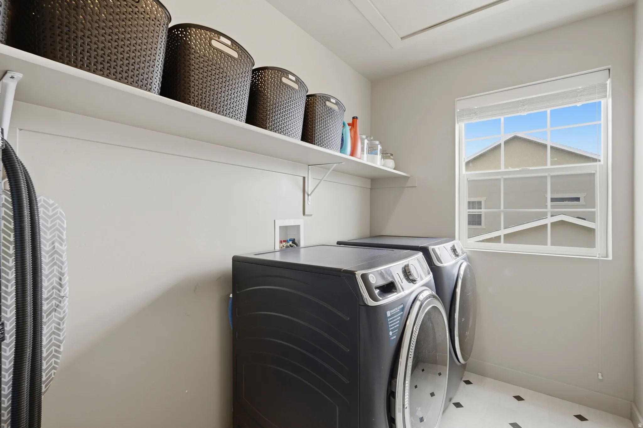 Laundry area with washing machine and clothes dryer