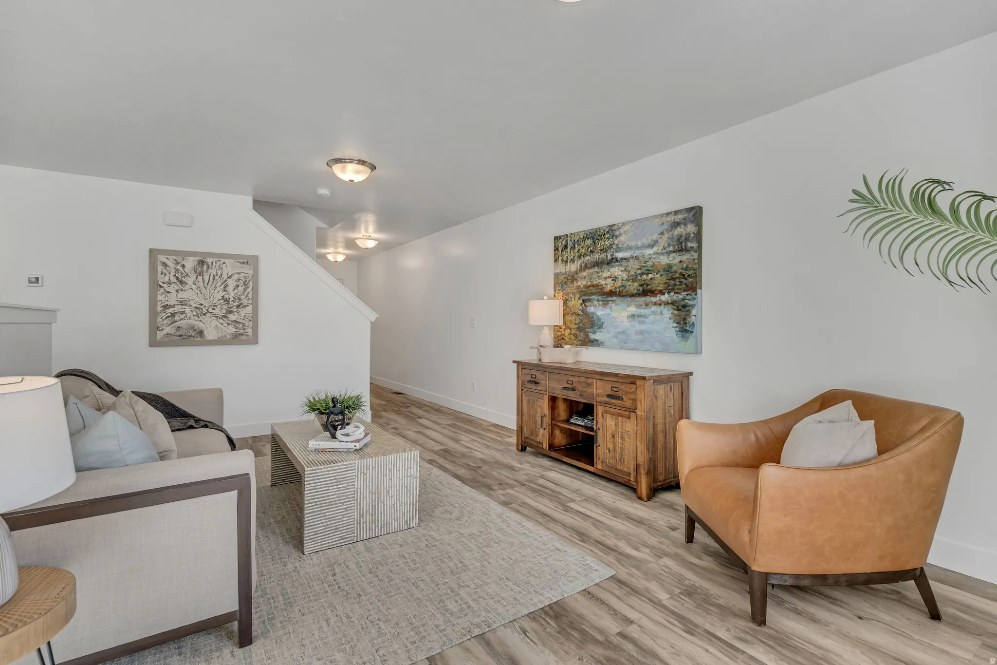 Living area featuring baseboards and light wood-style flooring