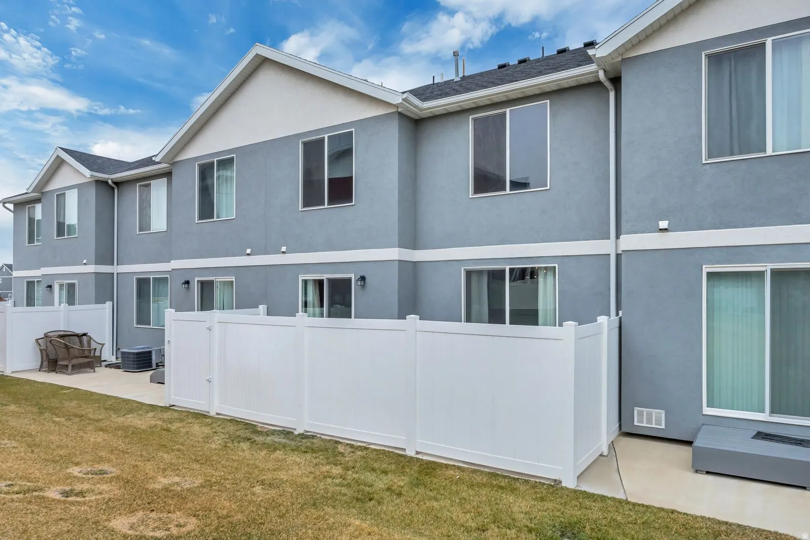 Rear view of house featuring stucco siding