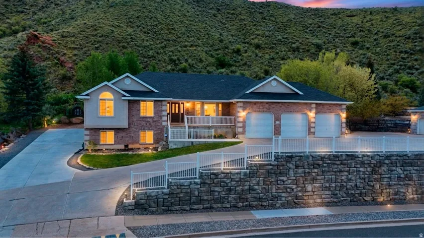 Single story home with a fenced front yard, covered porch, concrete driveway, and an attached garage