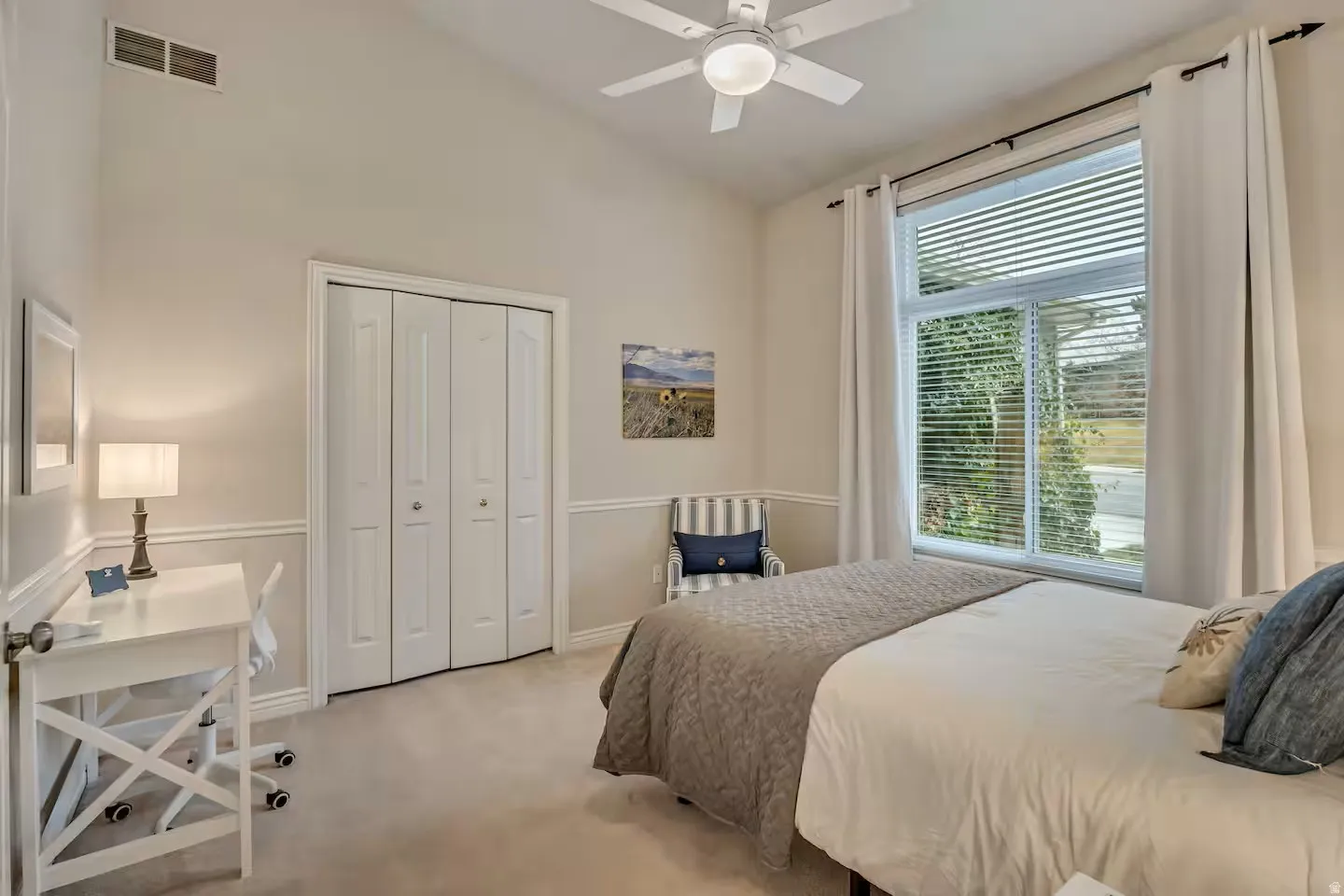 Bedroom with light carpet, lofted ceiling, ceiling fan, and a closet