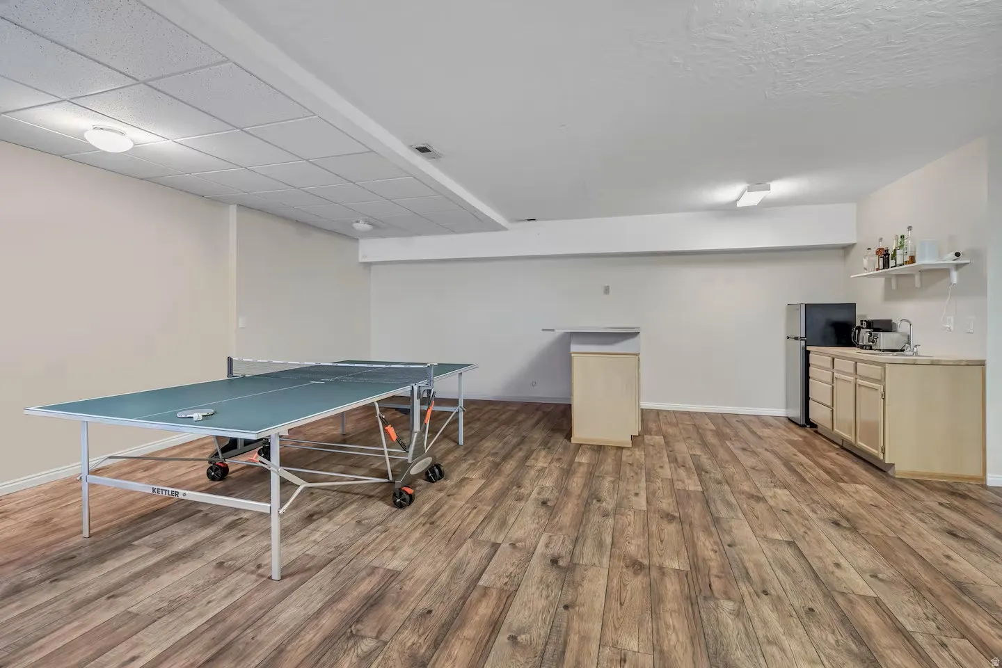 Game room featuring light wood-style flooring and baseboards
