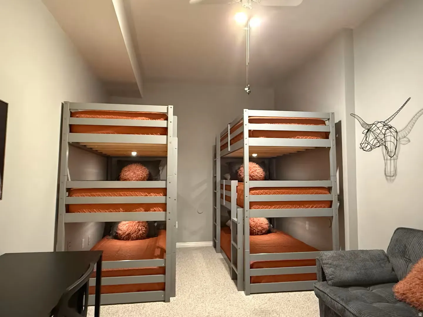 Bedroom with light colored carpet and a ceiling fan