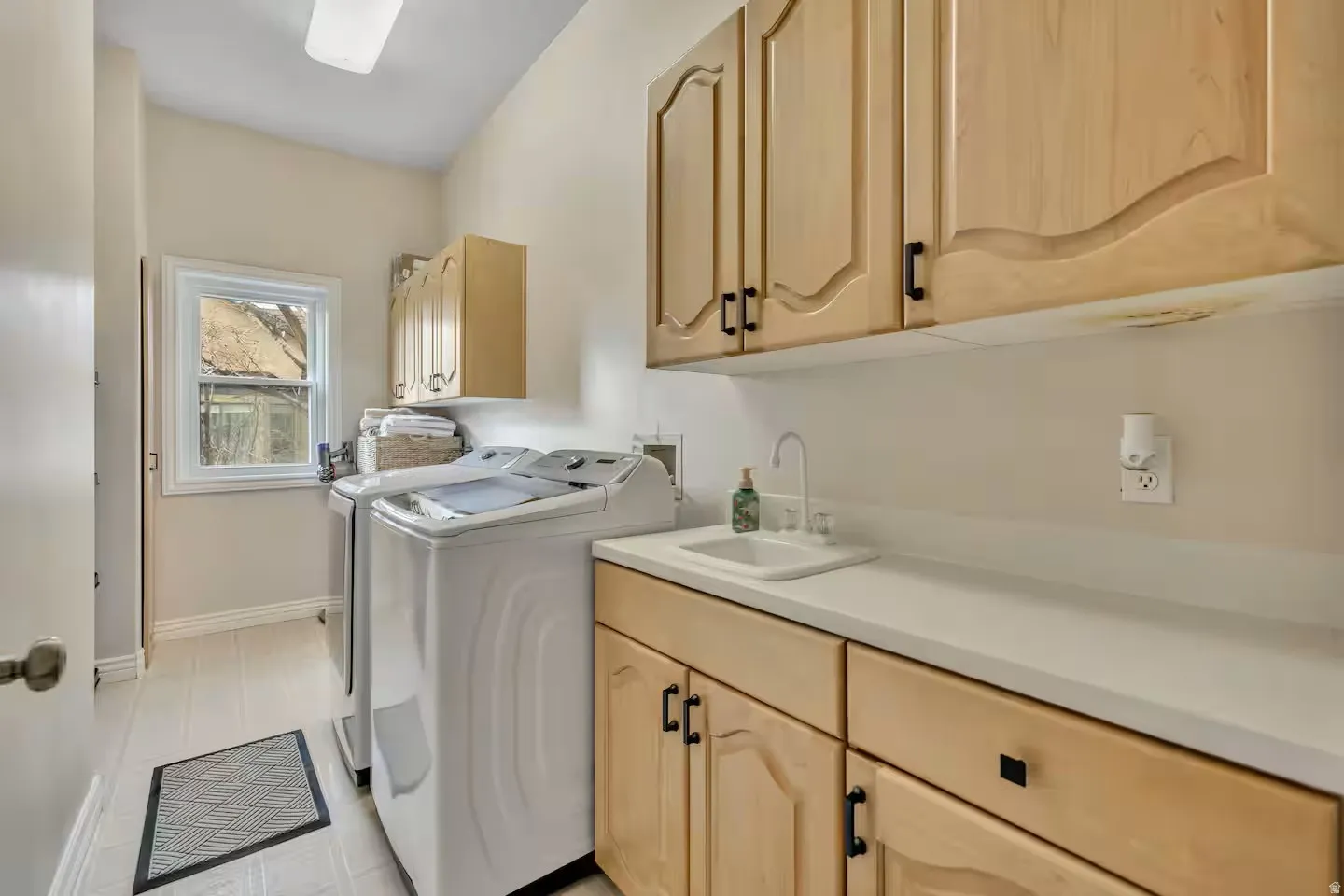 Laundry room featuring cabinet space and independent washer and dryer