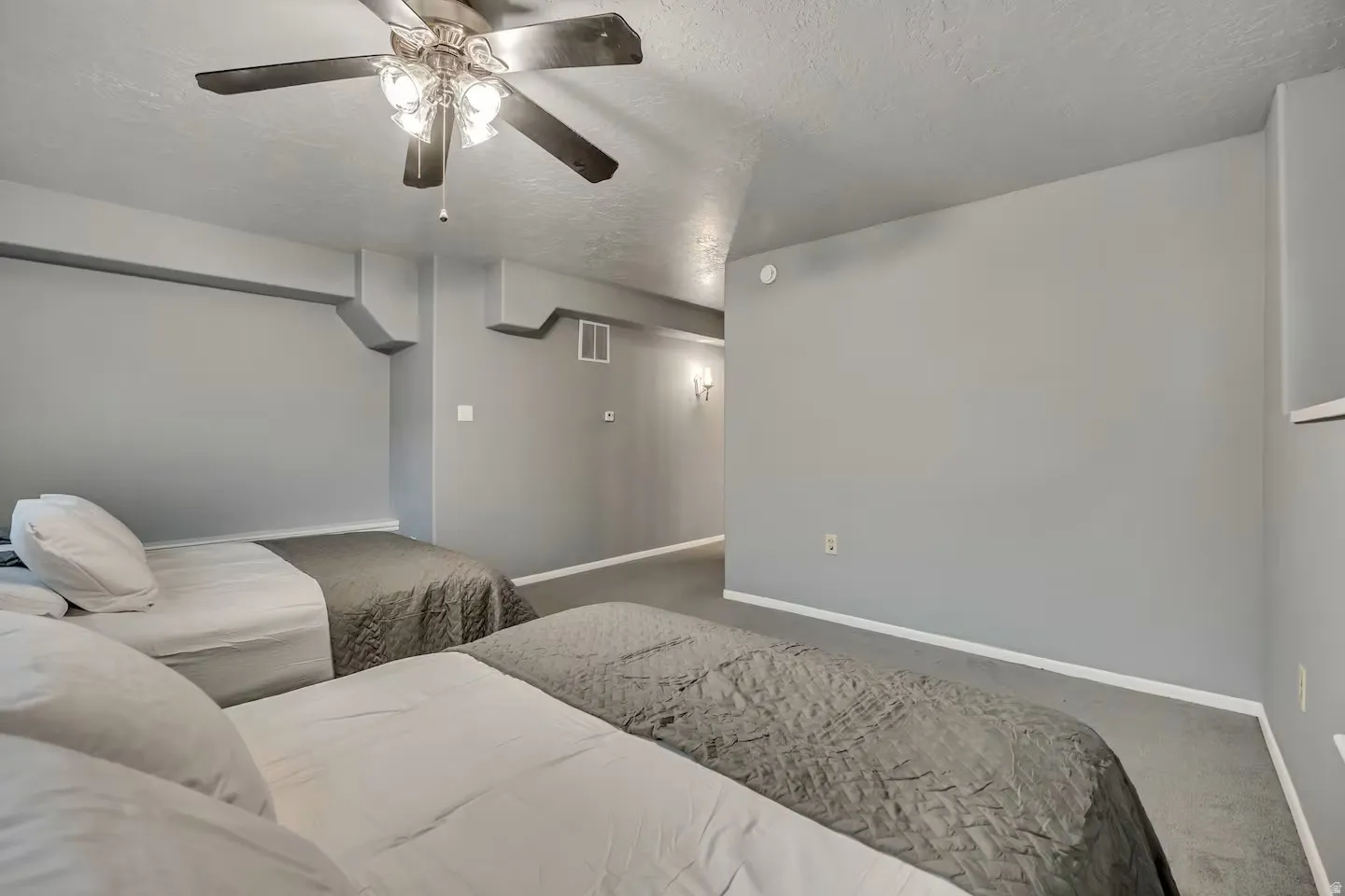 Home theater with a textured ceiling, a ceiling fan, and carpet floors